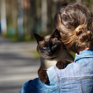 woman with cat on shoulder
