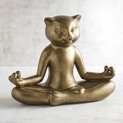 gold statue of cat in yoga pose