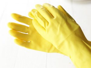 hands in yellow rubber gloves