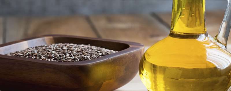 Bowl of flax and bottle of oil